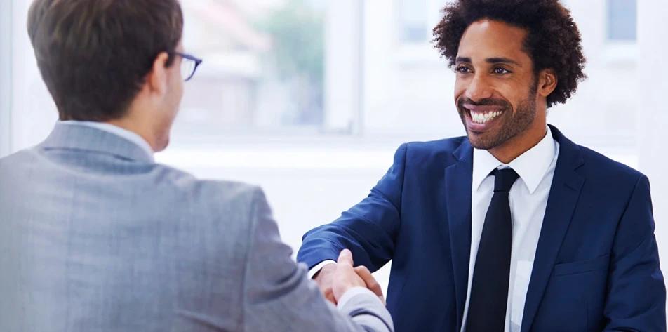 Two men in suits shaking hands